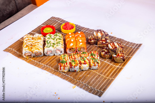Delicious Japanese sushi set with nigiri, maki rolls, and soy sauce served on a wooden board. Traditional Asian cuisine concept.