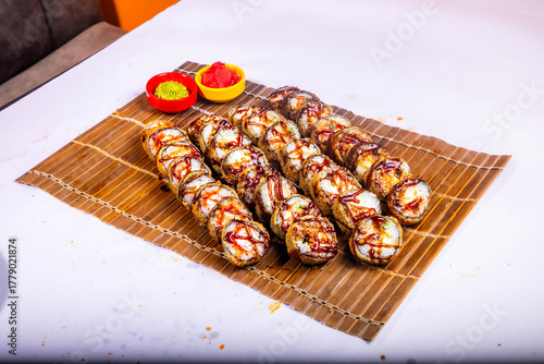Delicious Japanese sushi set with nigiri, maki rolls, and soy sauce served on a wooden board. Traditional Asian cuisine concept.