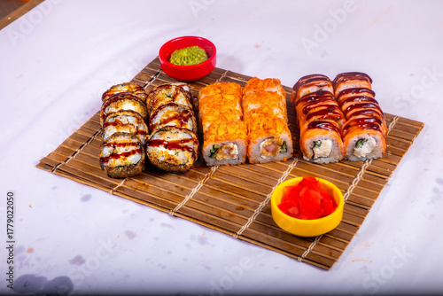 Delicious Japanese sushi set with nigiri, maki rolls, and soy sauce served on a wooden board. Traditional Asian cuisine concept.