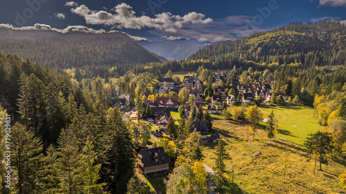 Fototapeta Naklejka Na Ścianę i Meble -  Mountain village in Poland surrounded by forests, autumn landscape, aerial view
