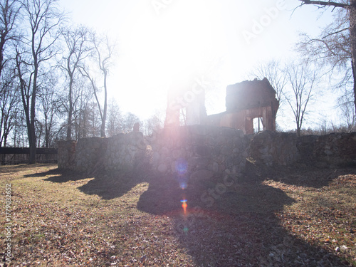 peaceful dawn illuminates solitary countryside house, quiet early morning landscape featuring house and leafless trees