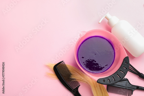 Tablou pe pânză Professional tools and products for hair dyeing on pink background, flat lay