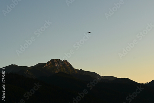 Giewont Mountain, Zakopane. Giewont peak seen from Cyrhla village. Cloudless summer evening. A drone is visible in the air