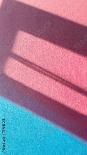 pink and blue wall with window shadows