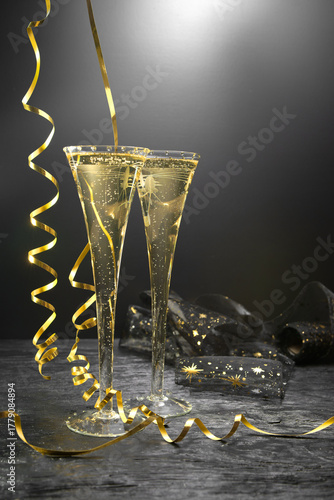 New Year concept, with bright light and champagne glass, abstract bokeh background