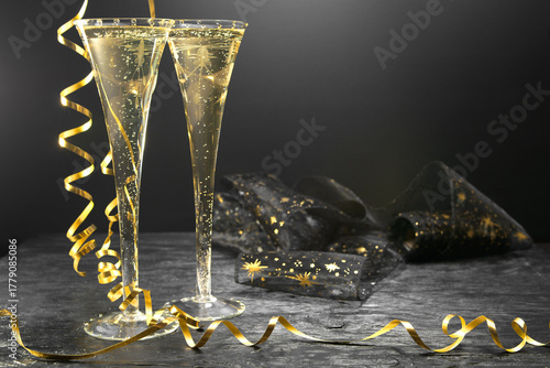 New Year concept, with bright light and champagne glass, abstract bokeh background