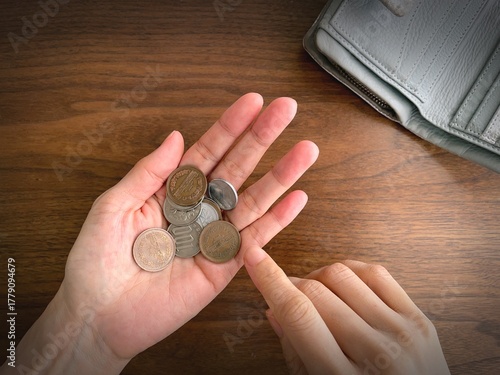 Photography Counting Japanese Coins in Hand – Personal Finance and Saving Concept