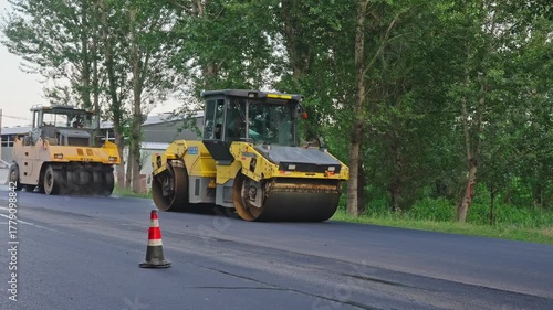Wallpaper Mural Workers are using large machinery to pave a road. Torontodigital.ca