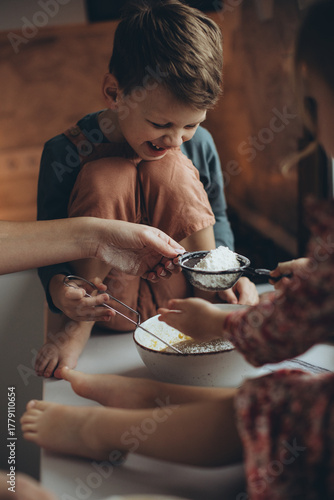 a little boy in the kitchen preparing food for the holiday