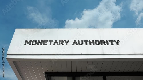 A monetary authority word sign displayed on a formal, governmental building under a clear blue sky, symbolizing central banking, financial regulation, and economic stability