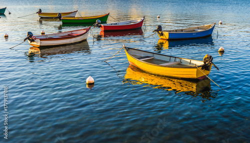 Wallpaper Mural Colorful boats float on calm blue water under a bright sky. Torontodigital.ca