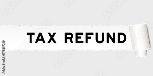 Ripped gray paper background that have word tax refund under torn part