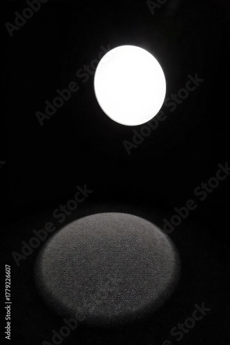 Enigmatic Shadow Play Abstract photography, dramatic chiaroscuro lighting casting sharp geometric shadows and soft organic shapes on a deeply textured, neutral toned fabric backdrop. High contrast,