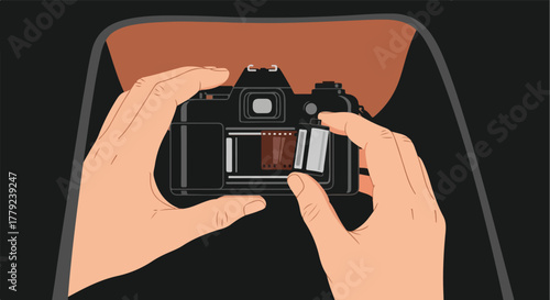 Hands load film into a classic camera