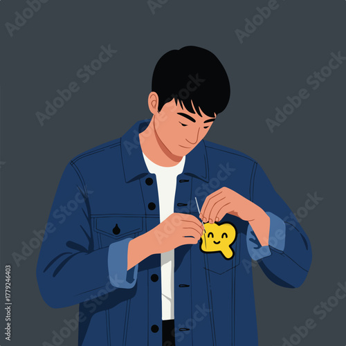 A person in a denim jacket carefully pins a yellow, smiling tag with a tail to their chest pocket