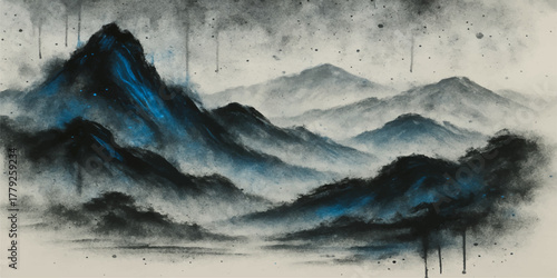 Blue mountains and clouds over a misty valley landscape at sunrise