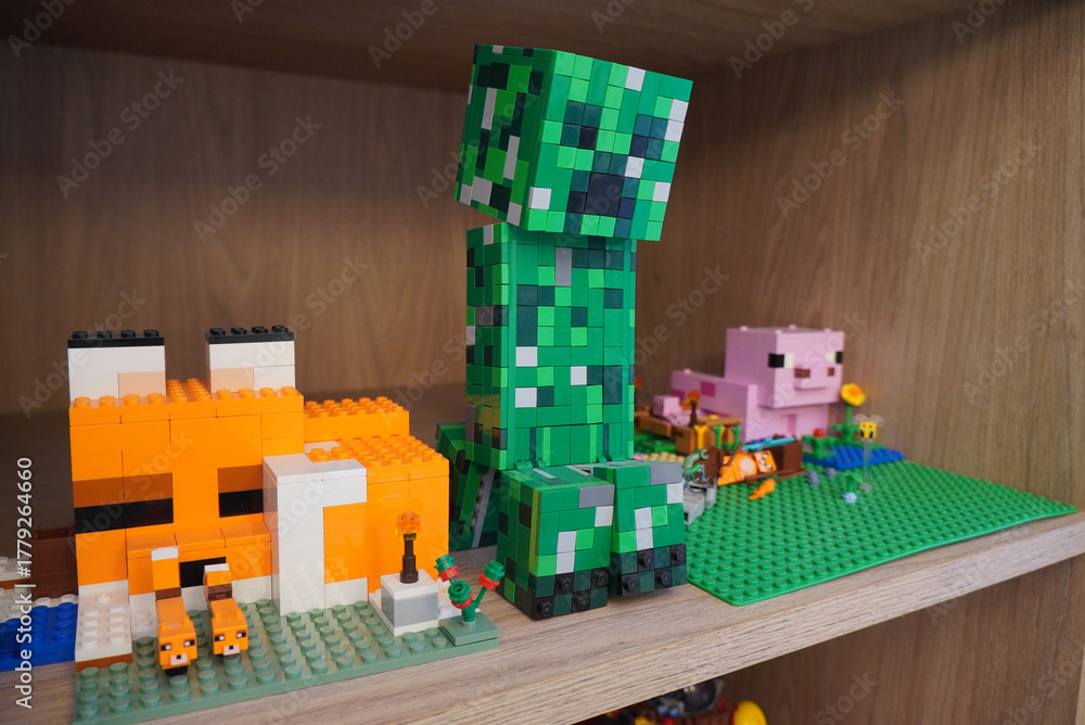 Naklejka premium Minecraft characters built with colorful toy bricks on a wooden shelf