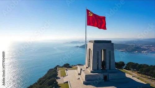 Animated communist flag with hammer and sickle waving over a coastal monument on a sunny day.