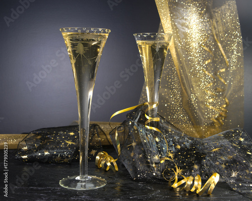 New Year concept, with bright light and champagne glass, abstract bokeh background