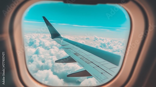 Airplane wing view from window above clouds high resolution photo