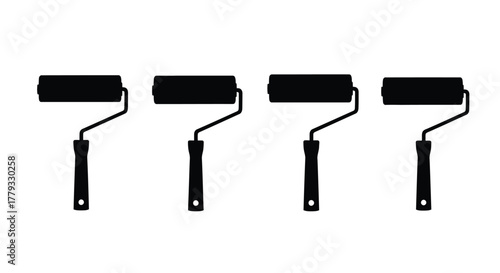 Four black paint rollers isolated on white background, painting equipment