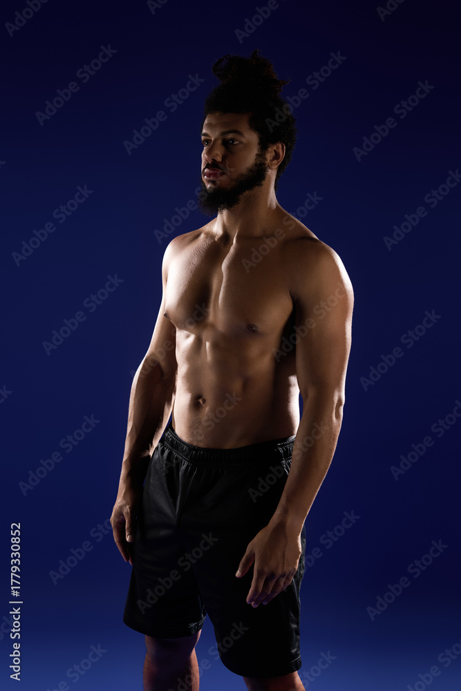 Fototapeta premium Athletic man shows strength and determination during a workout session