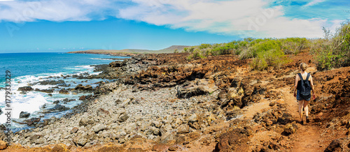 Female Hiker on Volcanic Landscape of Pohakumauliuli Beach, Molokai, Hawaii, USA