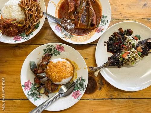 Malaysian style lunch called Nasi Campur. It is plain white rice served with protein, vegetable and other dishes.  Top view.