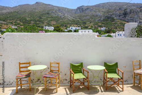 Fototapeta Naklejka Na Ścianę i Meble -  Tables and chairs on street in Lagada village on Amorgos island. Cyclades, Greece