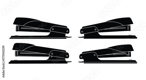 Four black staplers isolated on white background are arranged in a row