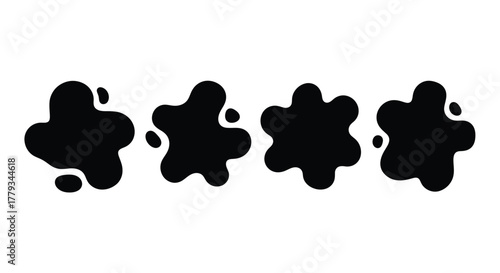 Four black ink blots are arranged in a row, isolated on white background