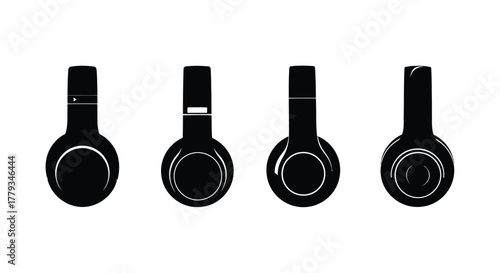Four black headphones in a row isolated on white background, studio shot