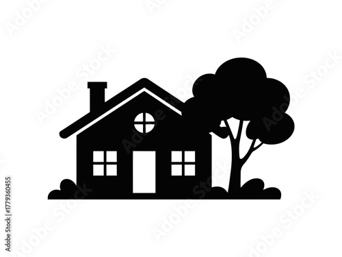 A silhouette of a house with a tree and bushes in the background.