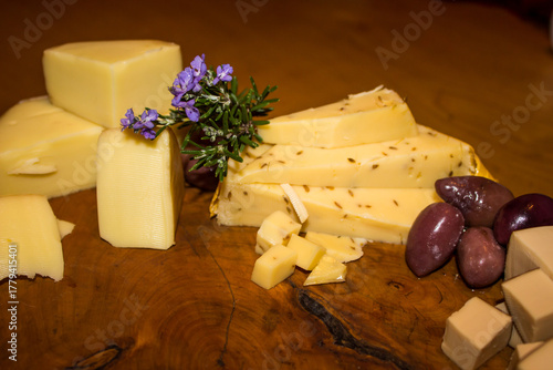 Tasting board with different types of cheese and olives.