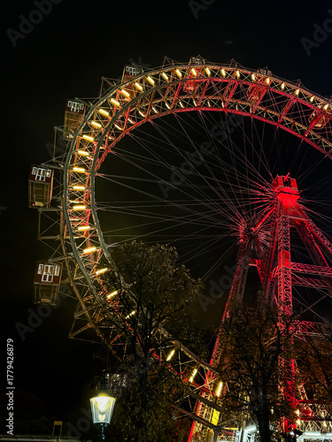Photography The Wiener Riesenrad, Illuminated giant Ferris Wheel glowing at night against da