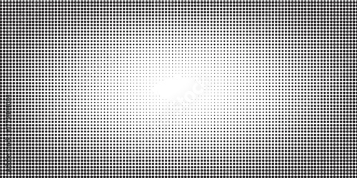 Grunge halftone dots pattern forming smooth gradient transition in monochrome.