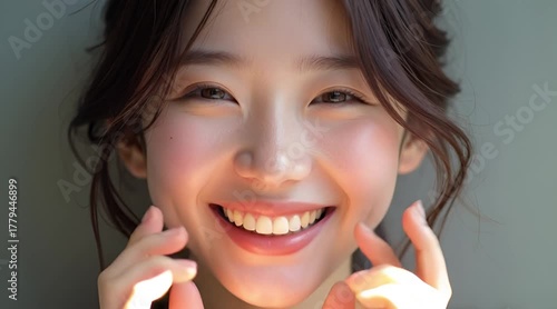 Close-up Portrait of a Beautiful Young Asian Woman with a Wide Genuine Smile and Radiant Complexion