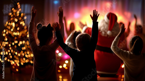 Warm defocused scene showing silhouettes of children dancing while faceless Santa waves hands to the rhythm of Christmas music, with copy space.