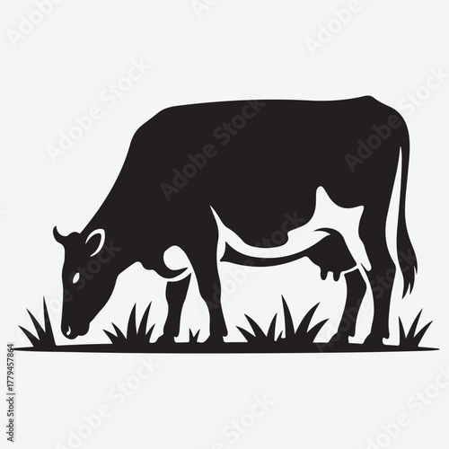 Black Silhouette of a Cow Grazing in Green Grass on a White Background