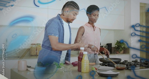 Chopping vegetables on cutting board and stirring frying pan in bright kitchen, digital overlay