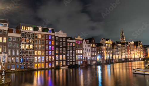 Amsterdam night city. Colorful houses canal water. lanterns evening reflection. Old Building architecture