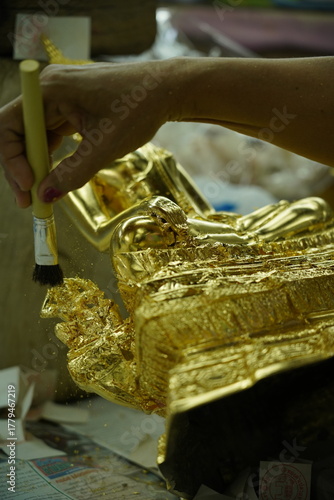 Thai Traditional Art: Gilding a Buddha Statue with Gold Leaf