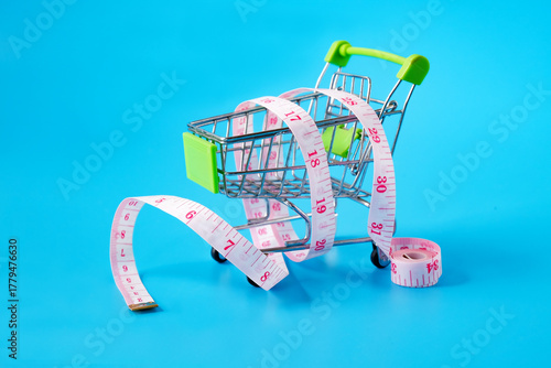 A shopping cart with measuring tapes,health concept.