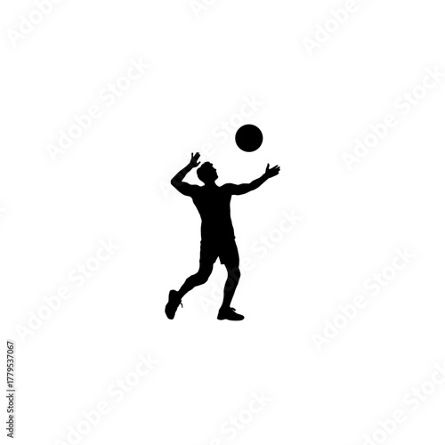 Silhouette of a male volleyball player in action hitting the ball during a game