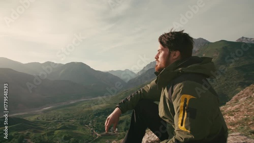 Wallpaper Mural Bearded man traveler sitting on mountain edge in morning light camera moving around concept of inner peace mindfulness sunrise freedom self discovery nature connection spiritual awakening Torontodigital.ca