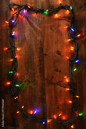 colorful christmas lights on old wood background
