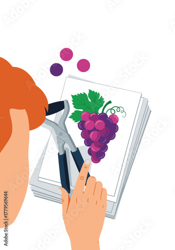 A person's hand holding pruning shears near a drawing of grapes and colorful dots.