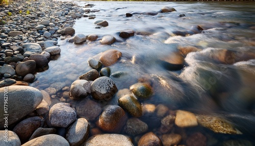 Shallow Water Flowing Over Riverbed With Many Smooth Round Rocks And Pebbles