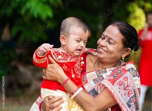 Happy Indian Grandmother Hugging Her Grandson Outdoors