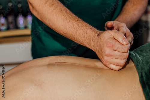Therapist performing deep tissue massage on client in spa setting